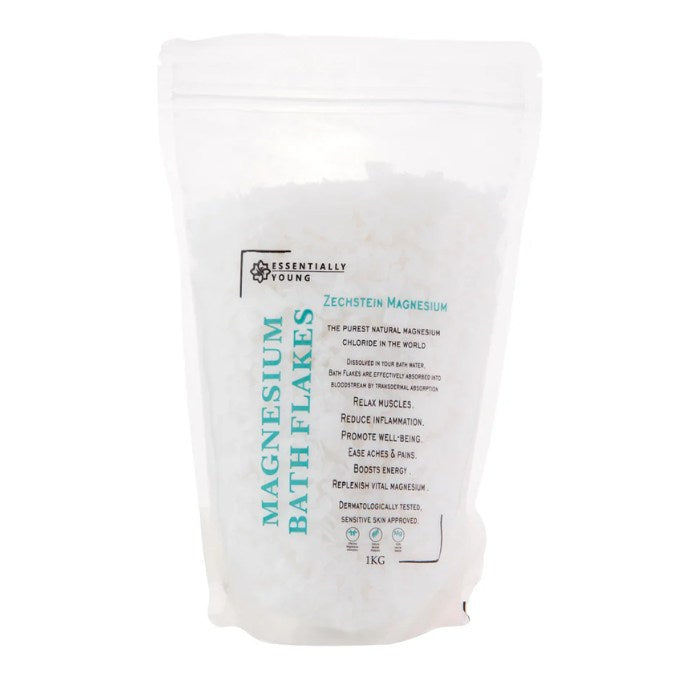 ESSENTIALLY YOUNG Zechstein Magnesium Bath Flakes in a 1kg resealable pouch, promoting muscle relaxation, inflammation relief, and skin wellness.