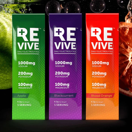 Close-up of REVIVE Daily Electrolytes sachets in Raspberry, Lemon Lime, Watermelon, and Peach flavours with vibrant fruit visuals.