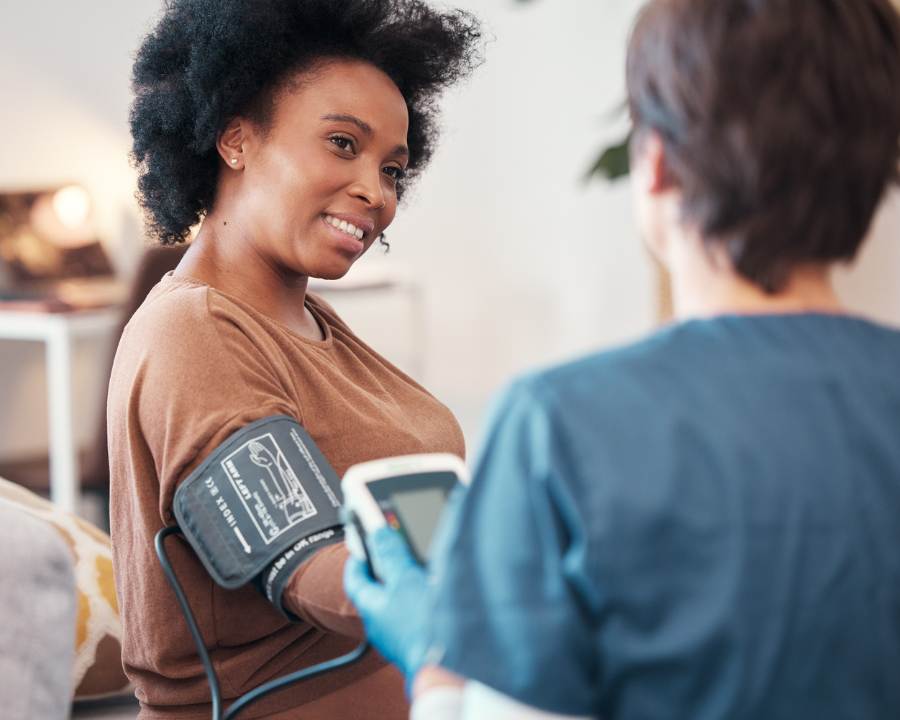 What Supplements Lower Blood Pressure – Woman having blood pressure checked by a healthcare professional.