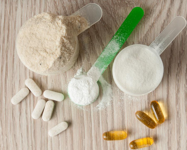 Amino pills with protein powder and capsules on wooden surface – The Good Stuff supplements for health and fitness