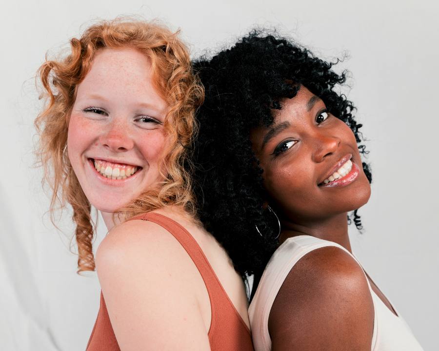 Beauty without Cruelty - The Good Stuff – two smiling women back to back; ethical vegan beauty and skincare.