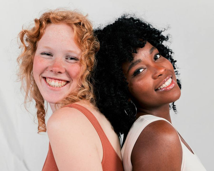 Beauty without Cruelty - The Good Stuff – two smiling women back to back; ethical vegan beauty and skincare.