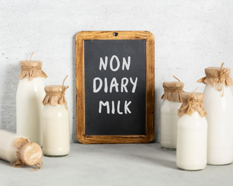 Dairy Free Supplements - The Good Stuff – dairy-free milk bottles and chalkboard; support lactose-intolerant wellness.
