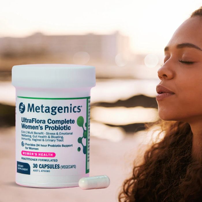 Metagenics UltraFlora Complete Women’s Probiotic – 5-in-1 support for stress, gut, and immune health, shown with serene woman