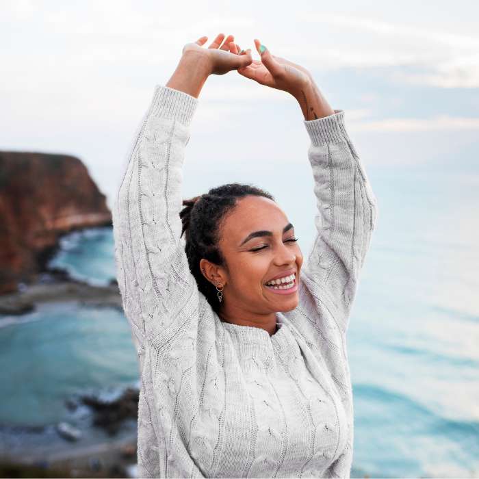 Smiling woman enjoying nature, promoting NMN Supplements in South Africa by The Good Stuff for vitality and wellness.