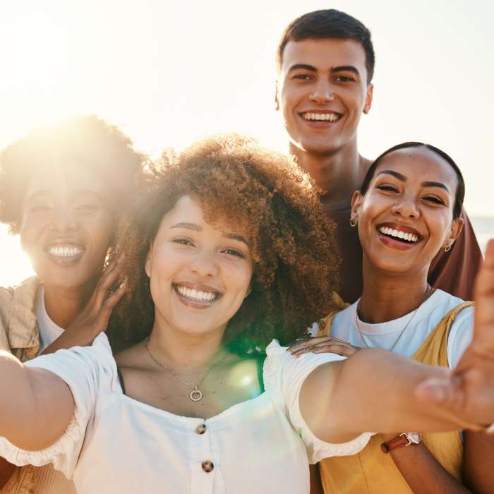 Group of friends enjoying a sunny day, representing the vitality and wellness promoted by NOW Foods supplements – The Good Stuff.