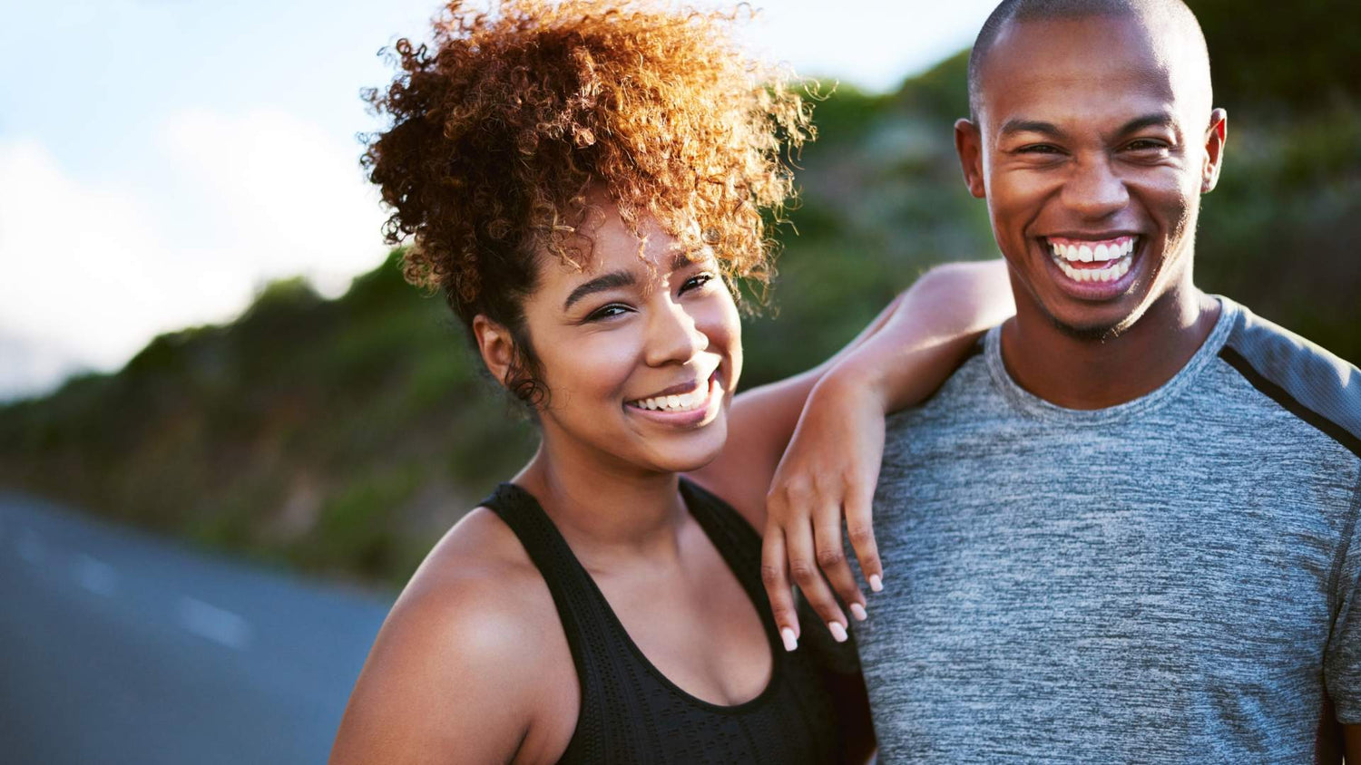 Smiling couple outdoors, representing the health benefits of Zeolite Powder from The Good Stuff collection.