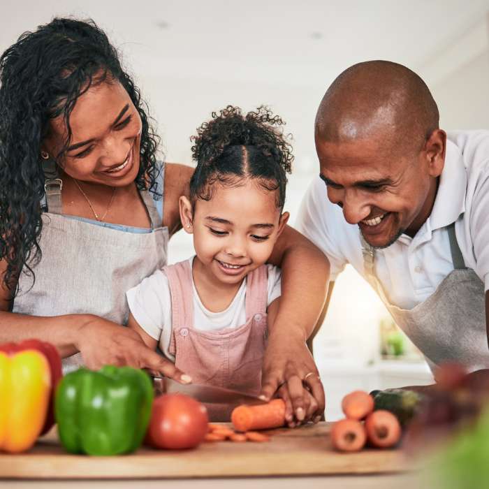 Happy family cooking together in the kitchen, promoting the use of Zinplex Tablets for a healthy lifestyle – The Good Stuff.